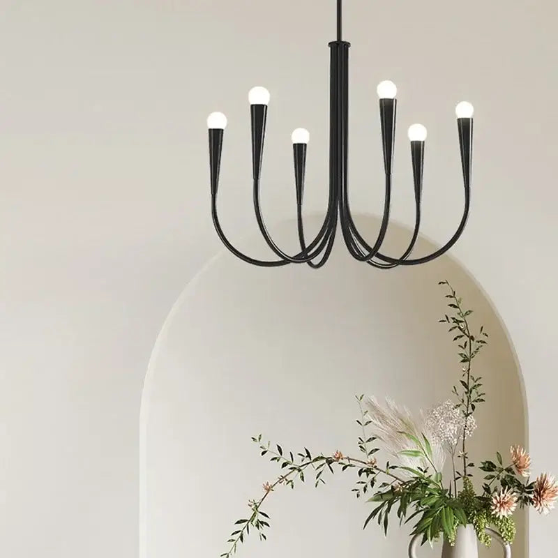Black wrought iron pendant light chandelier with six curved arms and frosted glass bulbs for dining room use