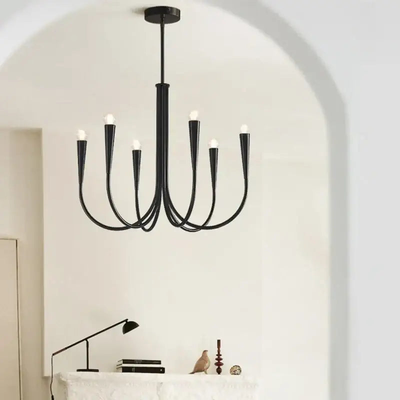 Black wrought iron pendant light chandelier with six curved arms and exposed bulbs for dining room lighting