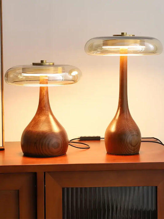 Two elegant french style walnut table lamps with smooth warm finishes and glass dome for bedroom lighting