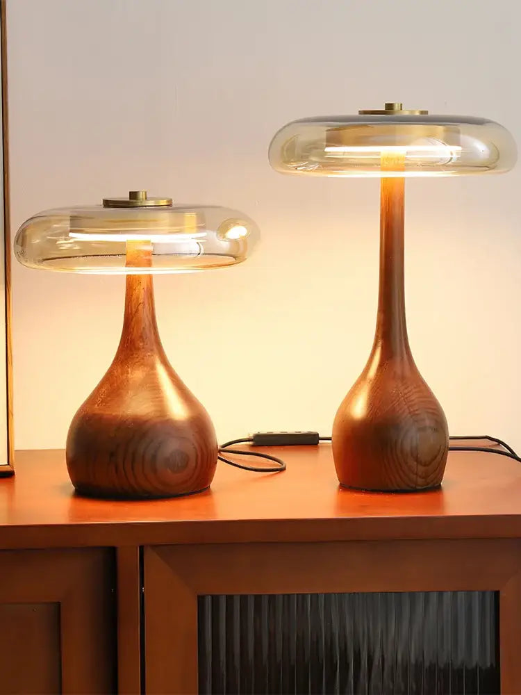 Two elegant french style walnut table lamps with smooth warm finishes and glass dome for bedroom lighting