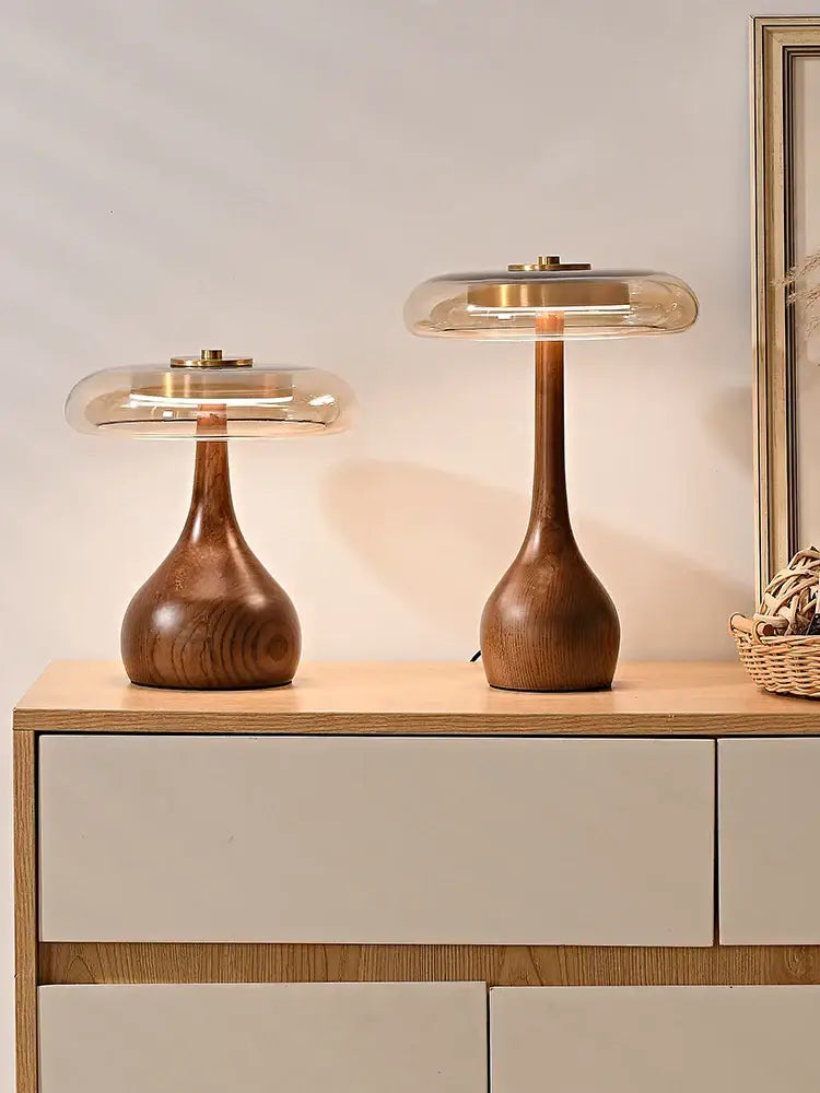 Two elegant walnut table lamps with clear glass domes and brass accents perfect for bedroom lighting