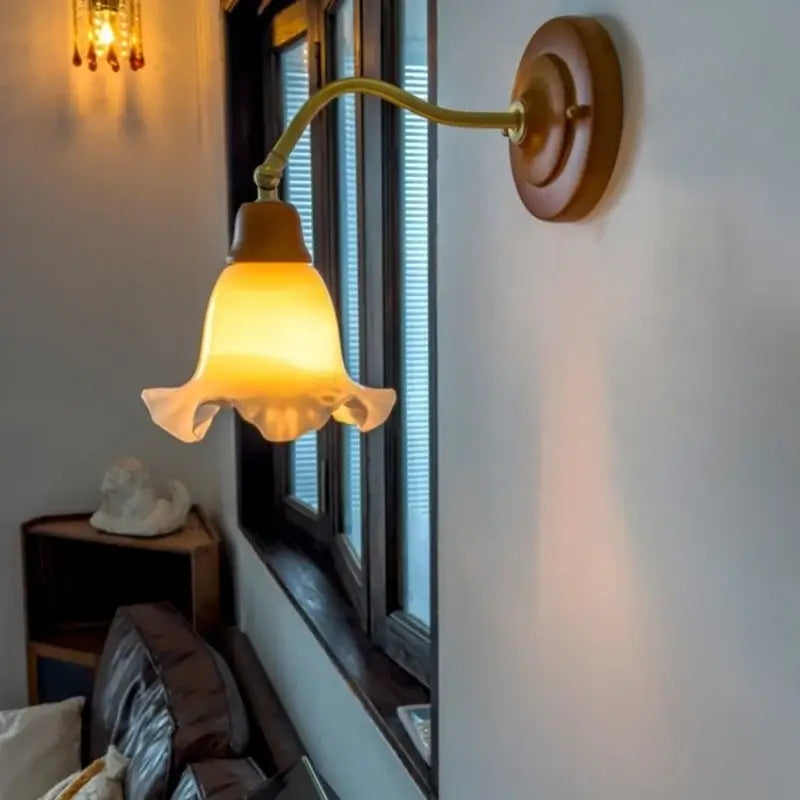 A warm amber-hued glass french vintage copper wall sconce with fluted shade and brass arm for decorbites bedroom decor