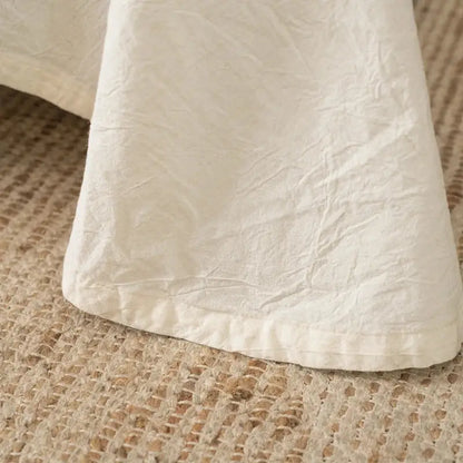A soft off-white cotton linen bed skirt with crinkled texture in French vintage cream bedding set decorbites cotton linen