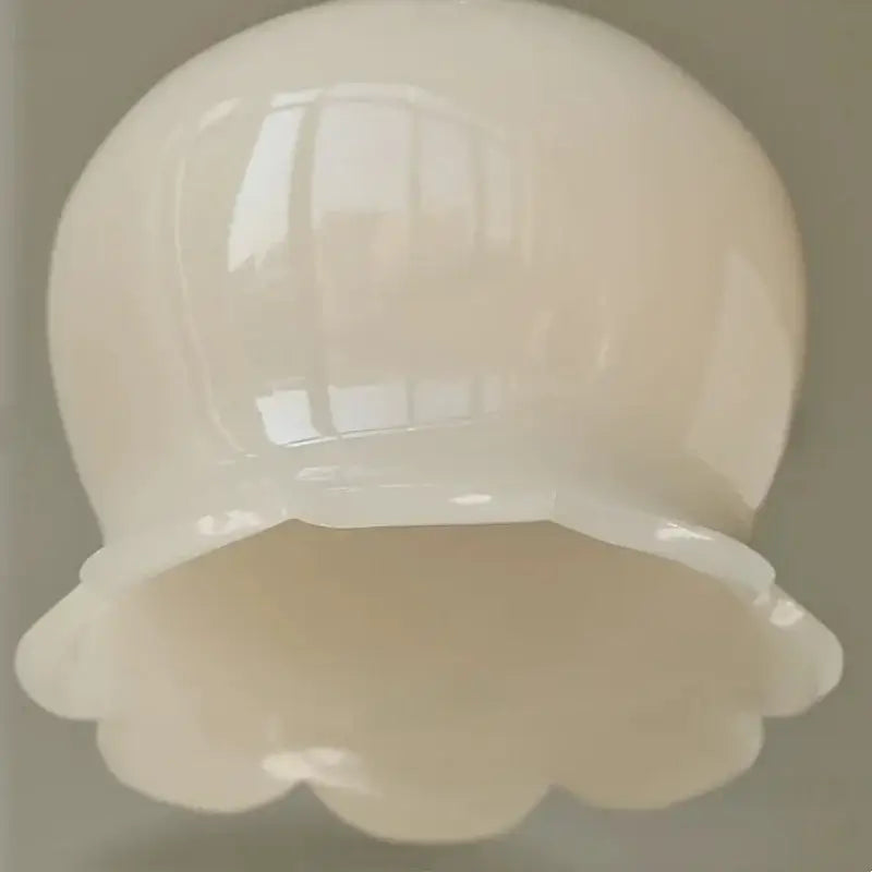 A glossy white ceramic bowl with scalloped rim featured in French vintage cream resin LED wall lights brass sconce decorbites cream resin