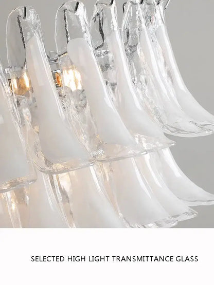A modern decorbites French white glass petal chandelier with translucent frosted pendant lights for dining rooms