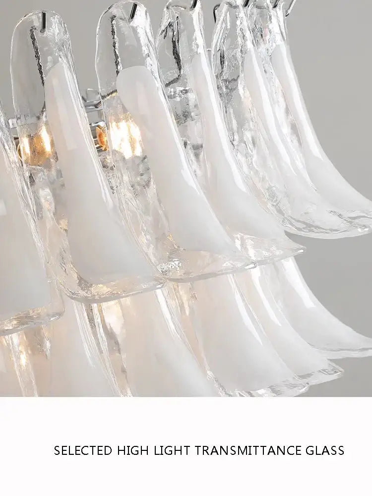 A modern decorbites French white glass petal chandelier with translucent frosted pendant lights for dining rooms