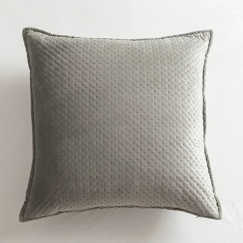 Gray quilted throw pillow with subtle diamond pattern and stitched edges in decorbites fringed velvet cushion cover