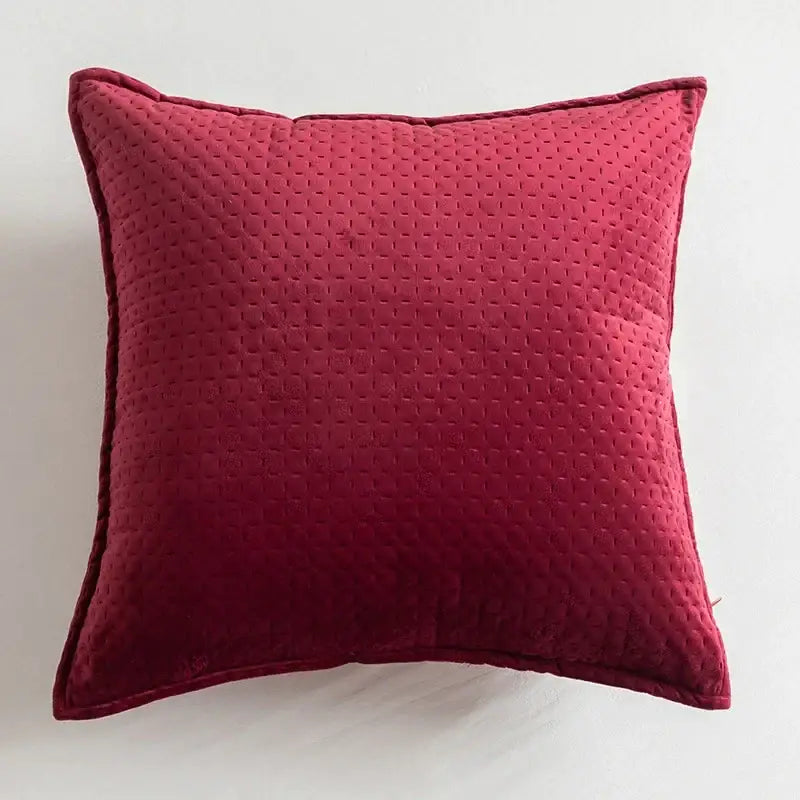 A plush deep red quilted velvet fringed velvet cushion cover from decorbites ideal for living room decor