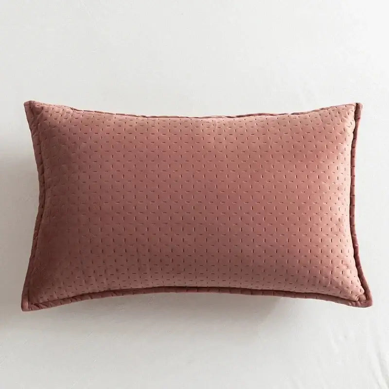 A soft rose-colored fringed velvet cushion cover with quilted texture and stitched edges for living room decorbites decor
