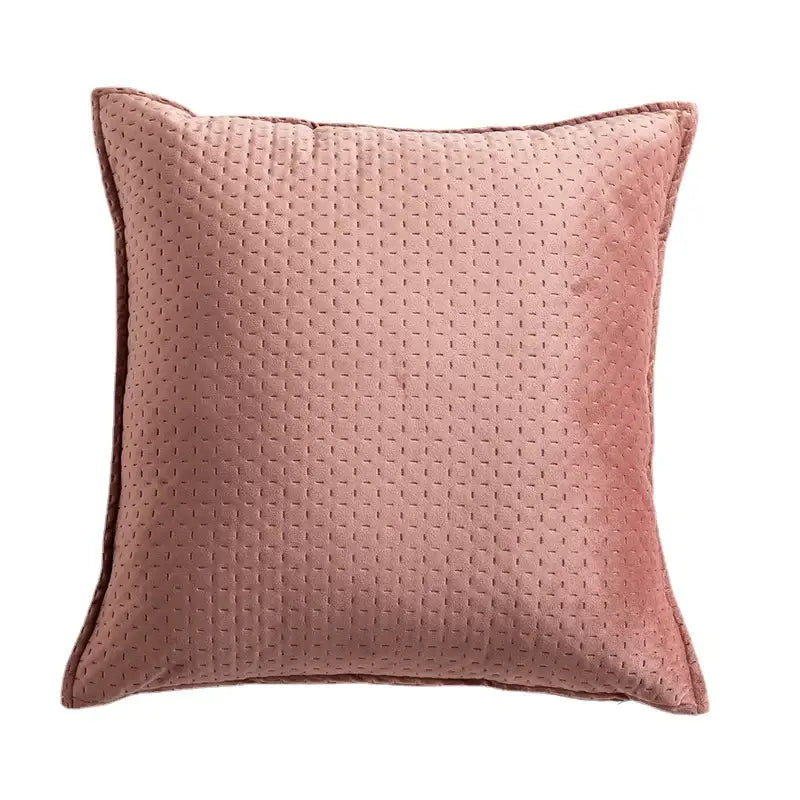 A soft rose-colored fringed velvet cushion cover with subtle quilted texture and neatly stitched edges for living room decorbites
