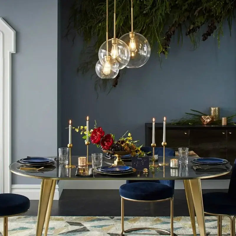 Gold-toned frosted and mirrored glass ball pendant light hanging above a dining table decorbites glass ball pendant