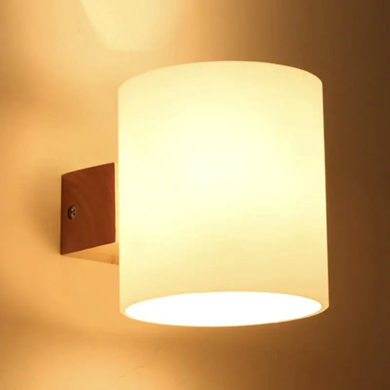 Warm-toned frosted glass copper wall lamp with wooden bracket for bedroom wall lighting and direct wired electric installation