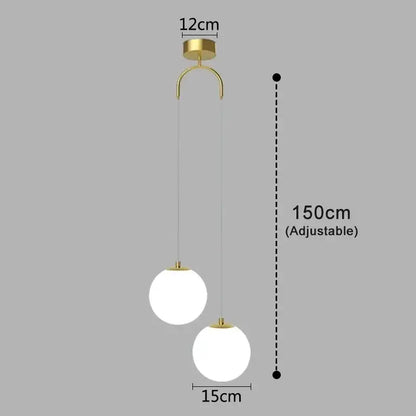 Gold finish glass pendant light with two frosted white glass shades suspended by adjustable cords for dining room