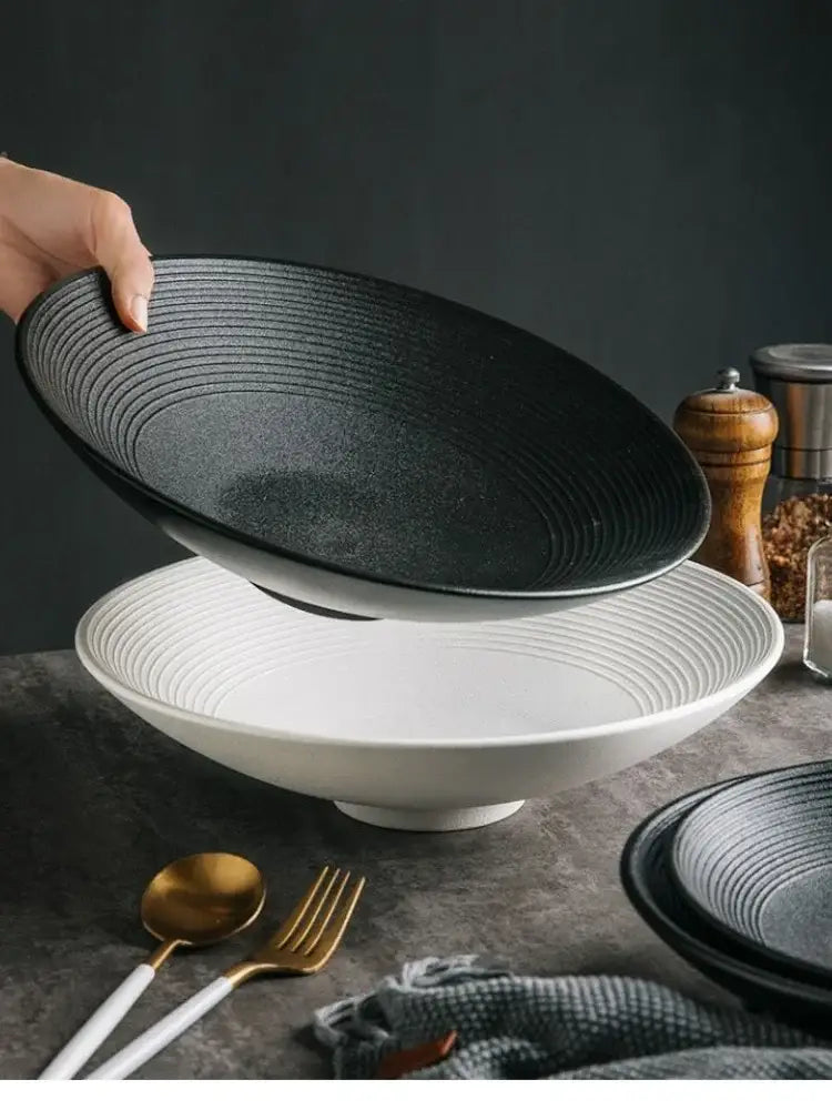 Black ceramic bowl with concentric ridged texture and subtle speckled finish from frosted glaze ceramic set by decorbites