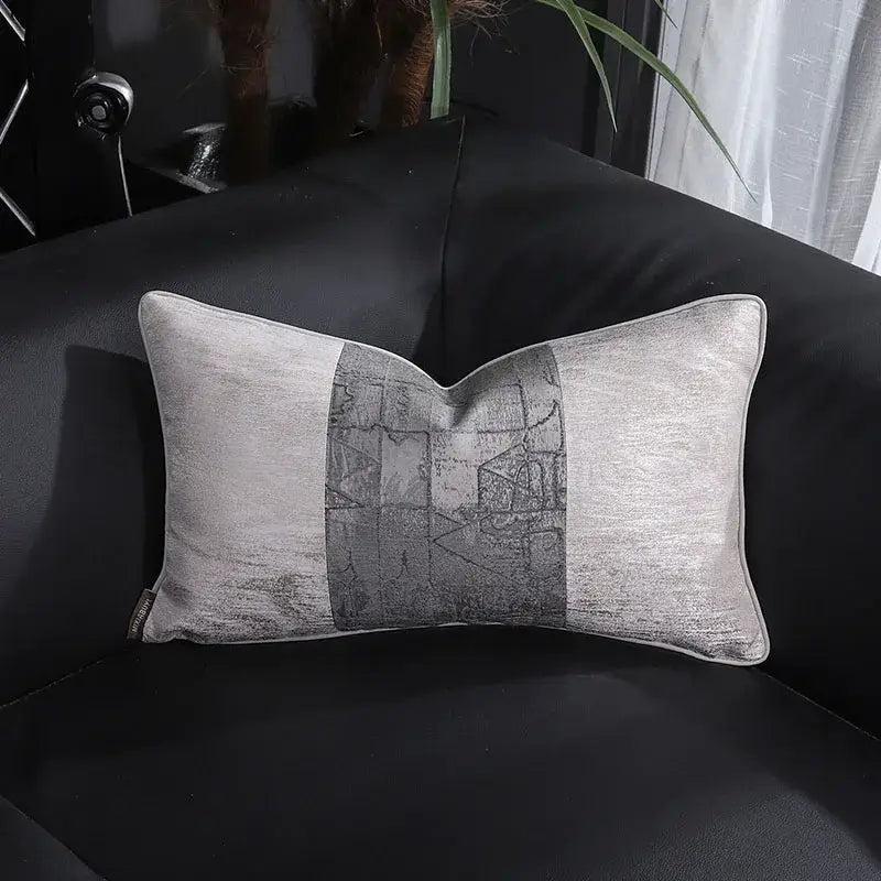 A rectangular gray pillow cover with a metallic sheen and abstract geometric panel from decorbites frosted gold satin collection