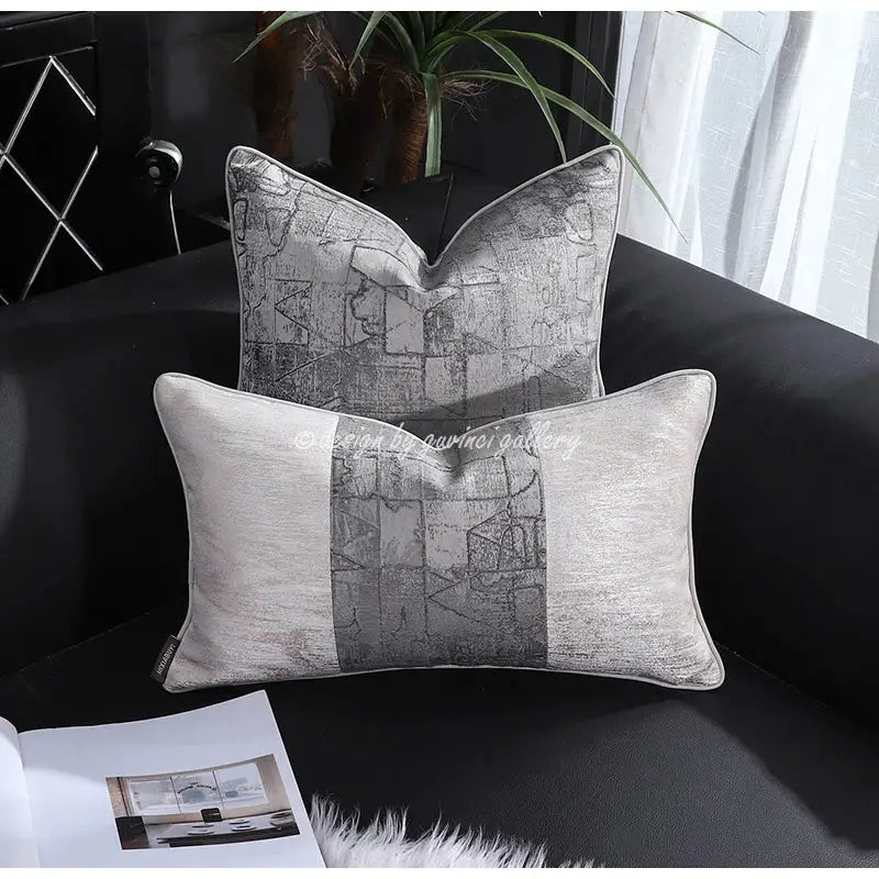 Two rectangular pillow covers with a modern gray and silver geometric pattern and textured fabric from decorbites frosted gold satin collection