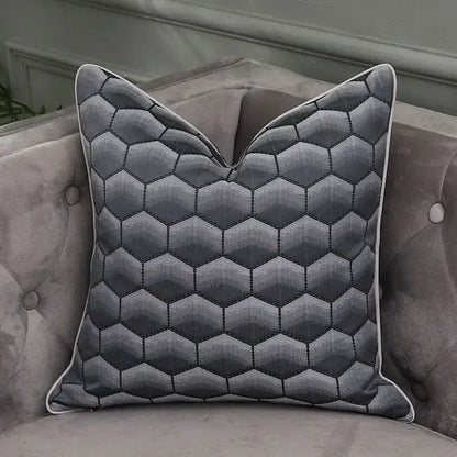 Gray hexagonal quilted pillow with white piping as pillow covers complementing decorbites frosted gold satin bedroom decor