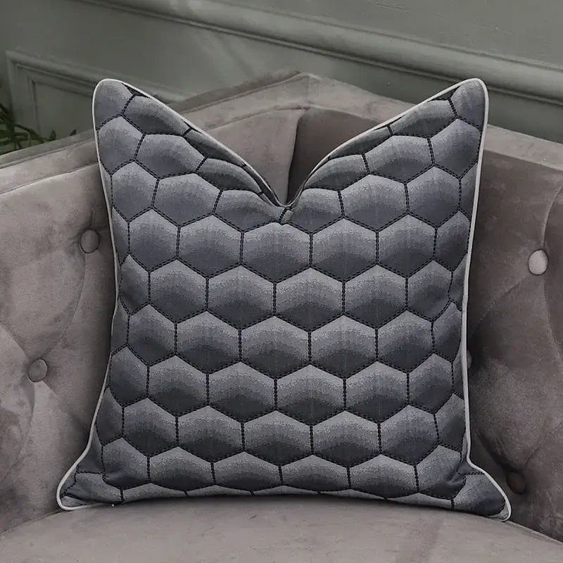 Gray hexagonal quilted pillow with white piping as pillow covers complementing decorbites frosted gold satin bedroom decor