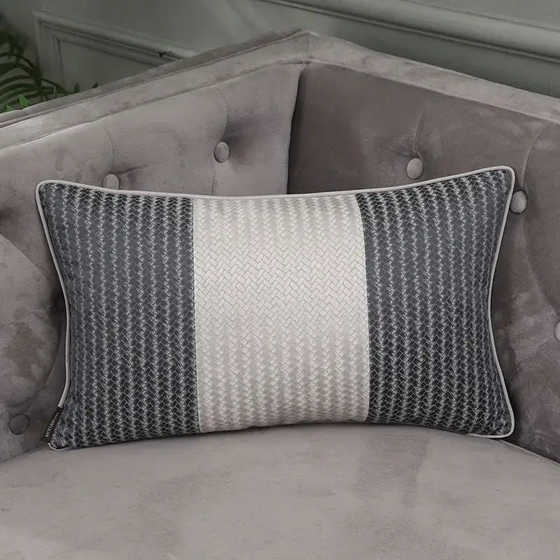 Gray and white striped pillow cover with woven texture on tufted gray sofa from decorbites frosted gold satin collection