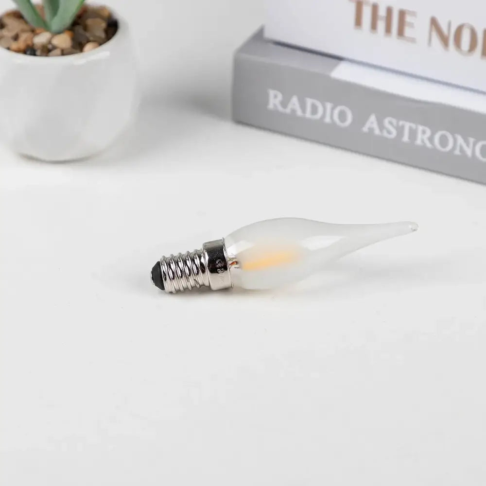 A frosted led candle bulb with a metallic screw base ideal for dining room chandelier lighting by decorbites frosted led