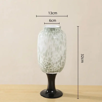 A translucent glass vase with frosted marbled dot texture and black pedestal base for living room decorbites decor