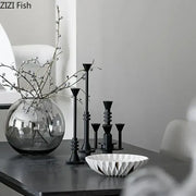A sleek round glass vase with delicate white berries complements decorbites frosted metal candle holder for romantic dining decor