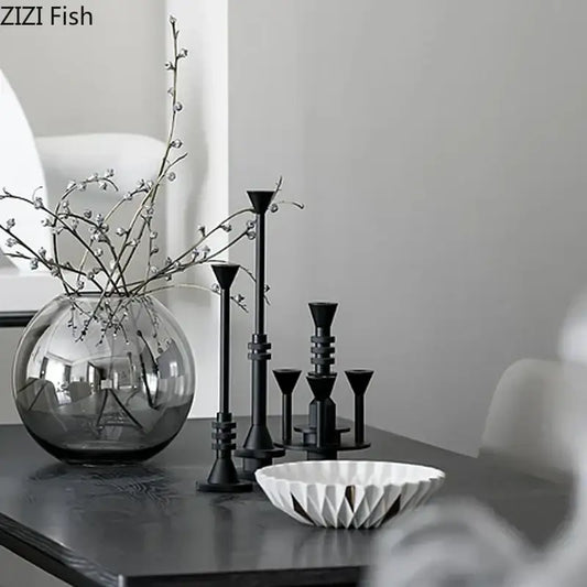 A sleek round glass vase with delicate white berries complements decorbites frosted metal candle holder for romantic dining decor