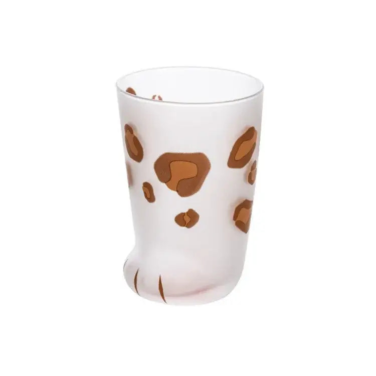 A frosted white glass shot glass with orange and black leopard spots and a cat paw shot base by decorbites cat paw