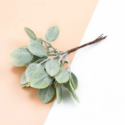 A delicate frosted light green artificial plants sprig with a dark brown stem from decorbites decorative artificial bundle