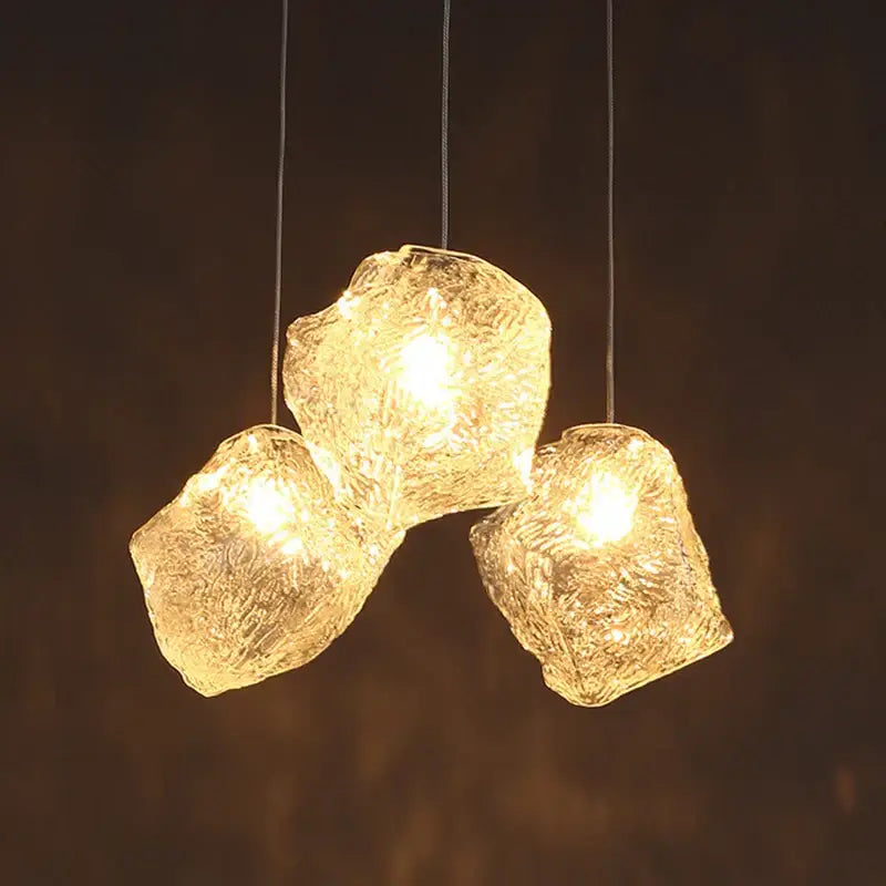 Three irregular frosted textured ice cake glass pendant lights with warm illumination for dining room decorbites pendant light