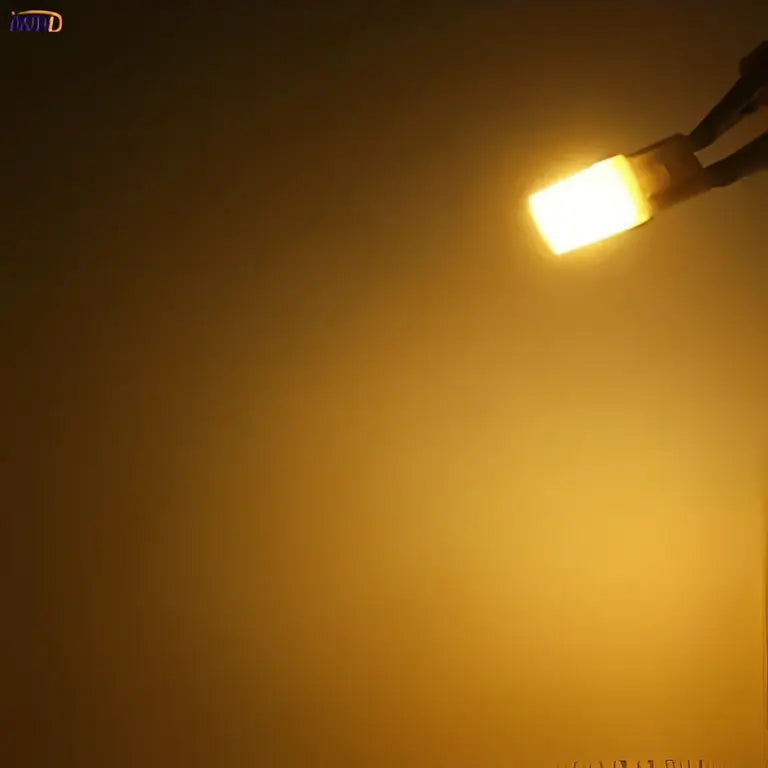 A warm glowing frosted white ceramic g9 led bulb with metallic base for energy-efficient lighting decorbites