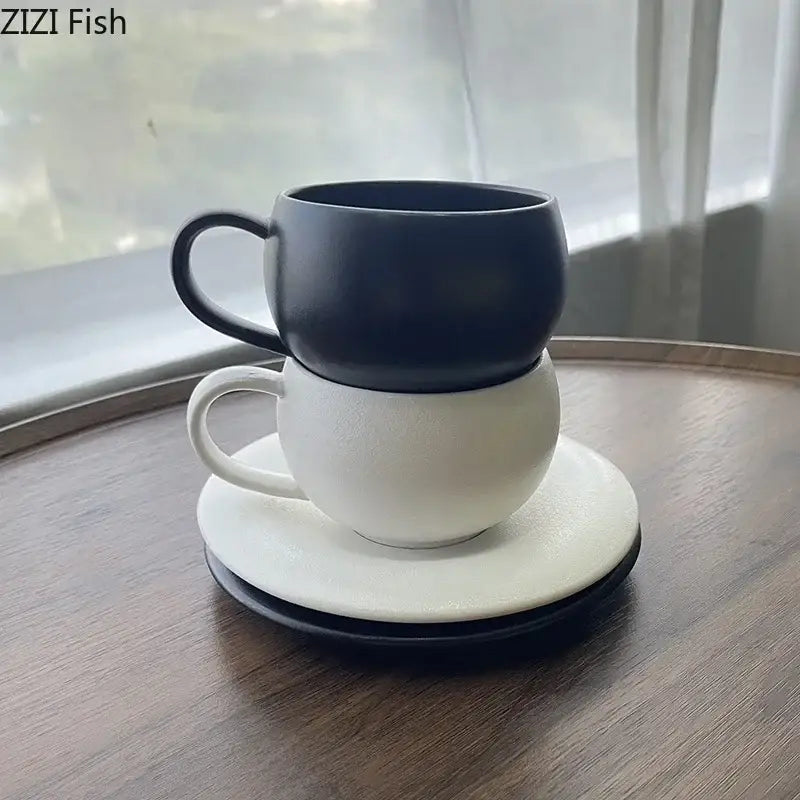 Black and white ceramic cup and saucer set stacked neatly on wooden surface decorbites frosted textured design