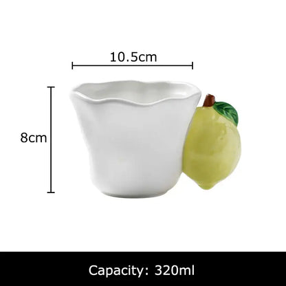 White ceramic fun fruits ceramic mug with a sculpted lemon handle featuring green leaves and a brown stem decorbites fun fruits