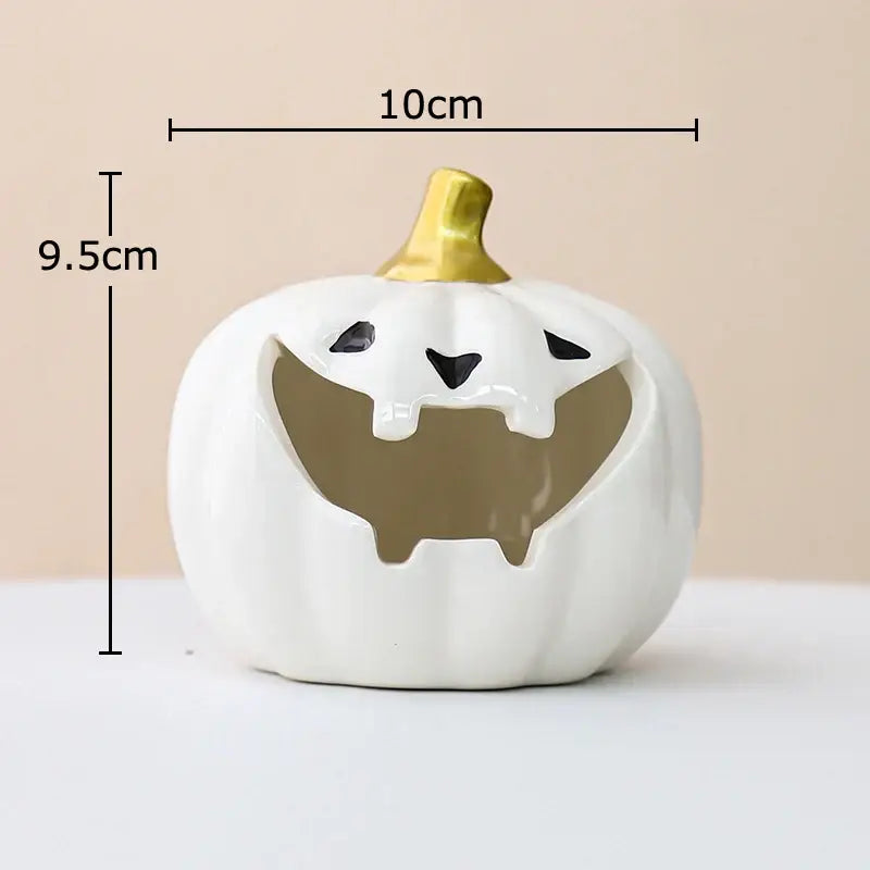 White ceramic halloween pumpkin ghost ashtray with gold stem and black cutouts for office decor