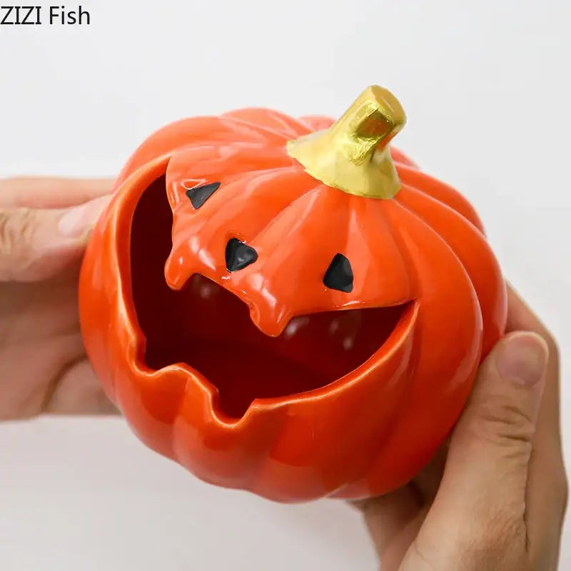 Vibrant orange ceramic halloween pumpkin ghost ashtray with black eyes and golden stem for office decor