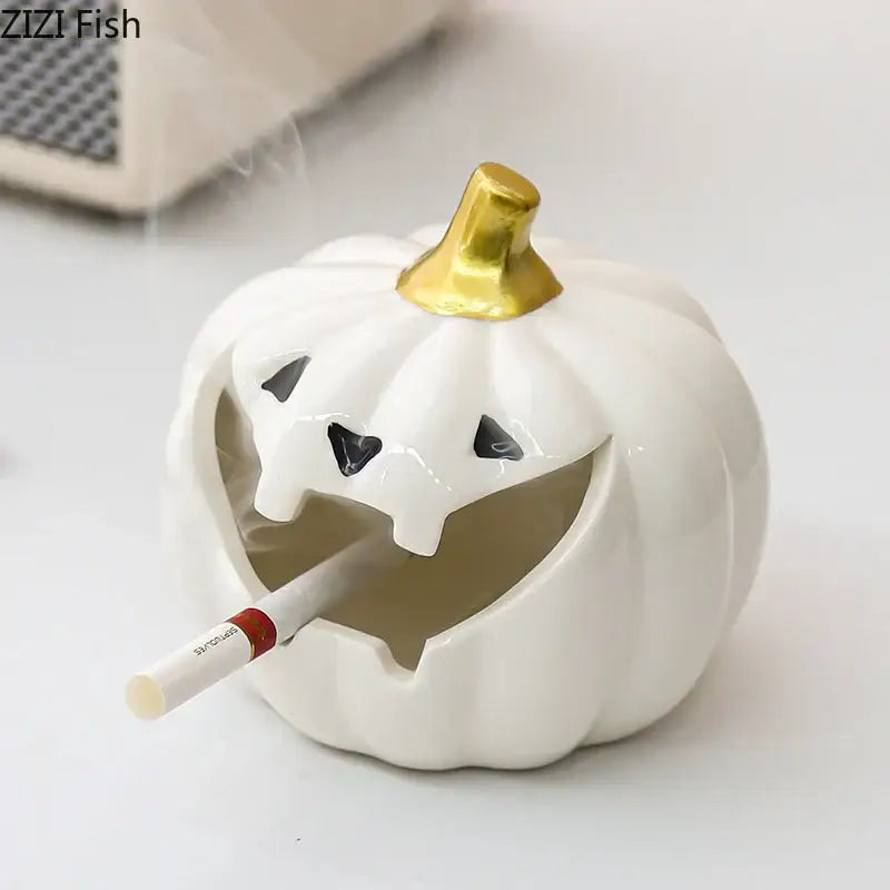 White ceramic halloween pumpkin ghost ashtray with gold stem and carved smiling face for office decor