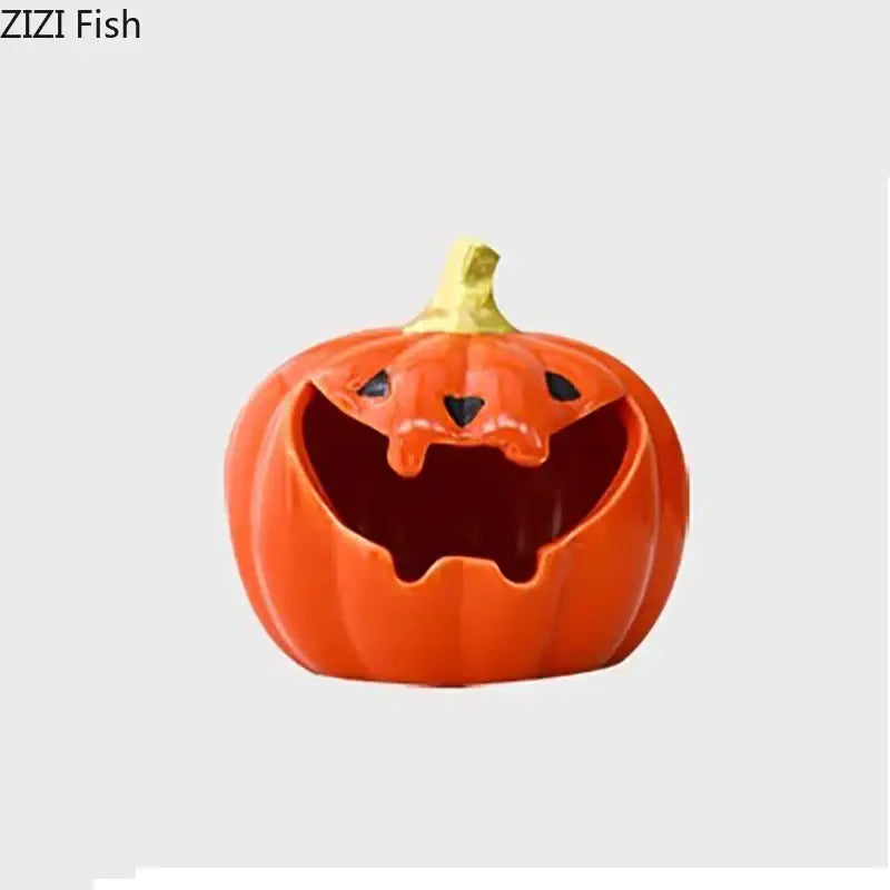 Funny orange ceramic halloween pumpkin ghost ashtray with black carved eyes and mouth topped with a gold stem for office decor
