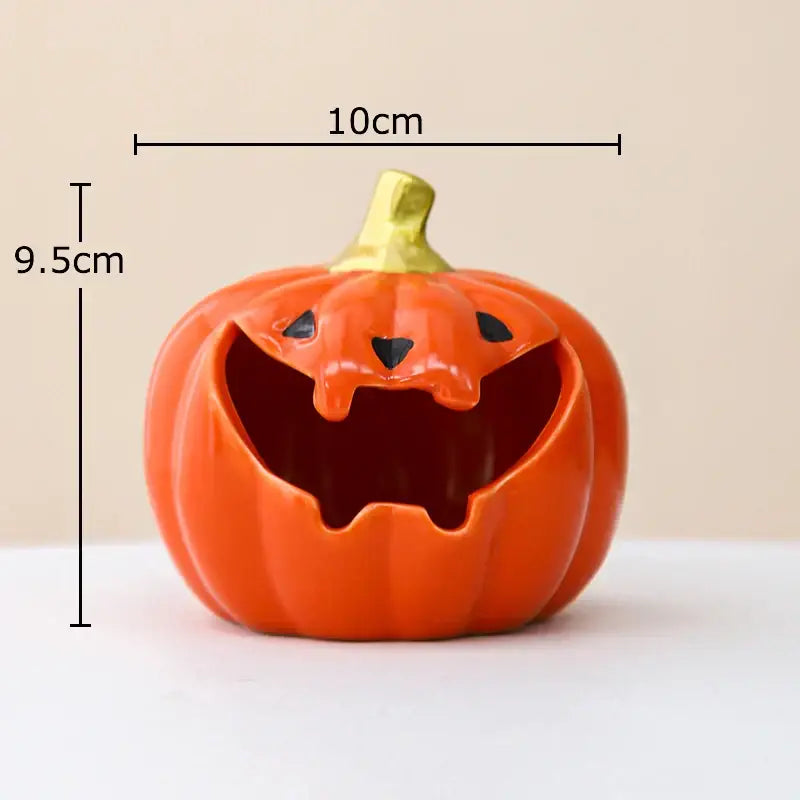 Funny orange ceramic halloween pumpkin ghost ashtray with gold stem and black eyes designed as decorative storage container