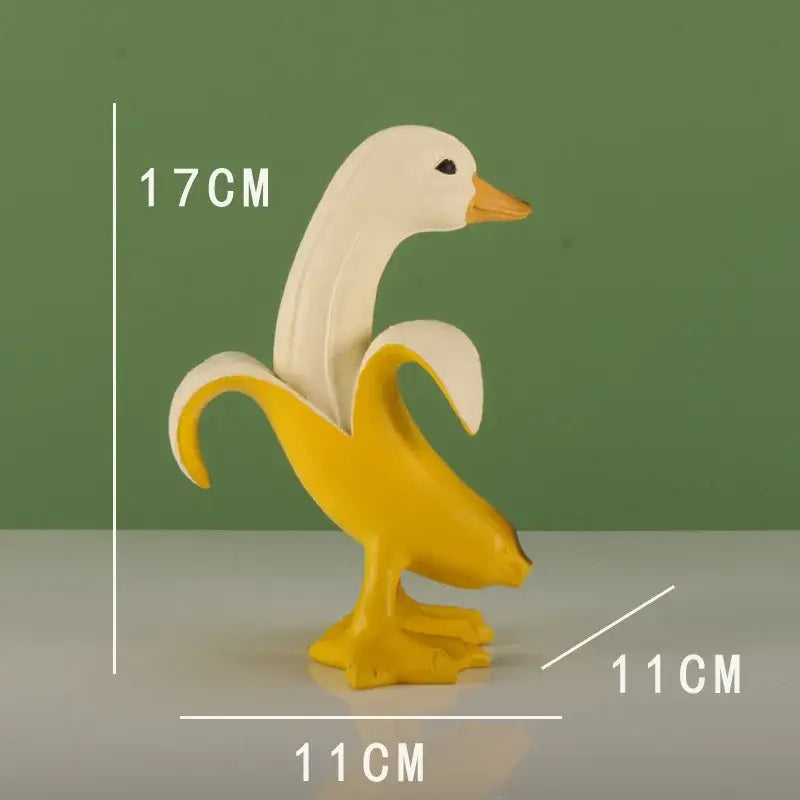 Whimsical white and yellow banana duck sculpture made of smooth plastic for living room decor