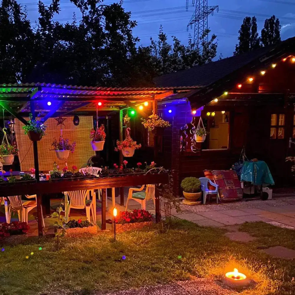 A cozy outdoor patio lit by decorbites g45 white string lights with globe led bulbs and a warm candle