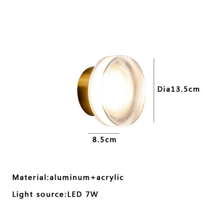 Modern wall sconce lamps with circular brass-finished aluminum base and translucent acrylic diffuser for living room lighting