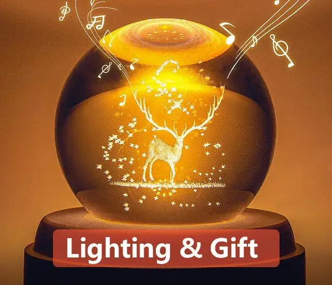 Golden illuminated crystal ball music box featuring a glowing deer silhouette with musical notes and stars in a wooden base