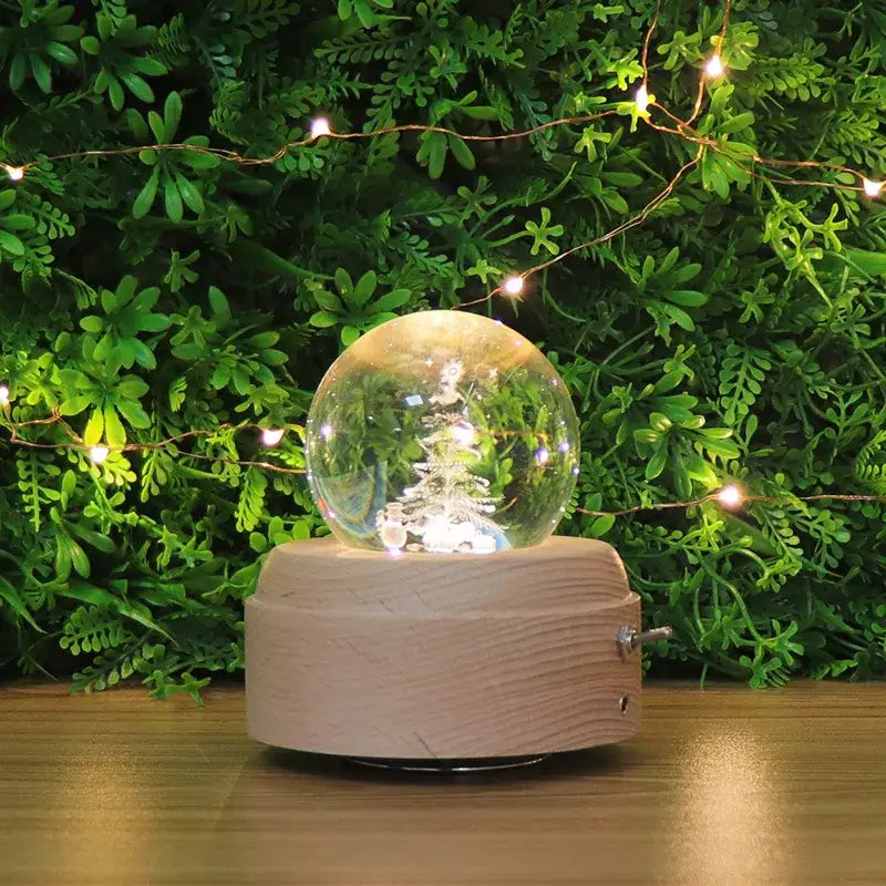 Clear glass crystal ball music box with miniature christmas tree and light wooden base for bedroom decor
