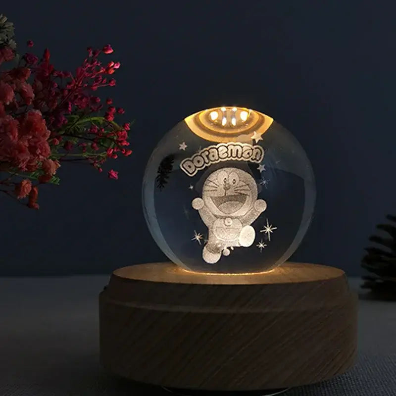 Clear glass doraemon-themed led crystal ball music box with wooden base for bedroom rotating light glow