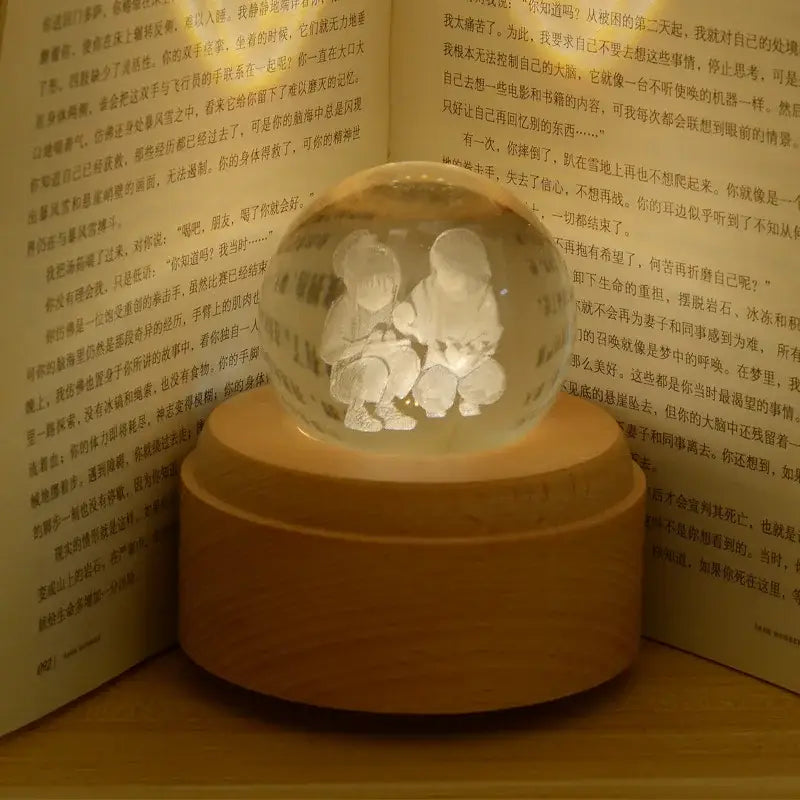 Translucent glass crystal ball music box with engraved children inside galaxy rotating wooden light glow design
