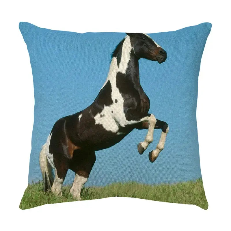 Square linen throw pillow featuring a vivid black and white pinto horse rearing against a bright blue sky decorbites galloping horse