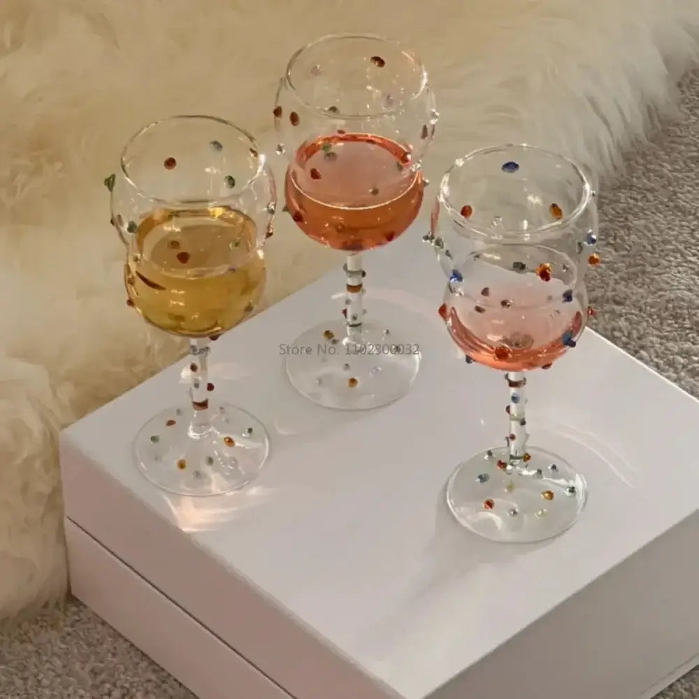 Three clear crystal gem spark coupe goblets with colorful gemstone accents and gold bead detail for dining decorbites gem spark