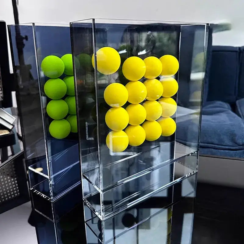 Clear acrylic geometric abstract acrylic ball ornament display box with vibrant yellow and green foam balls in grid pattern