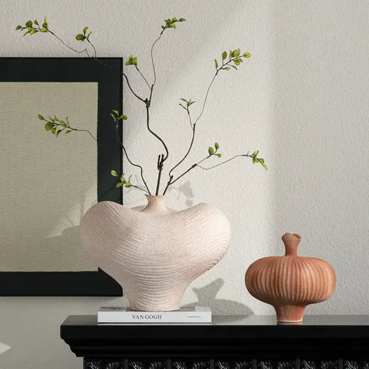 A blush pink geometric abstract ceramic vase with a ribbed textured surface for living room decorbites decor