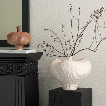 Cream-colored geometric abstract ceramic vase with textured wavy surface and heart-shaped form for living room decor
